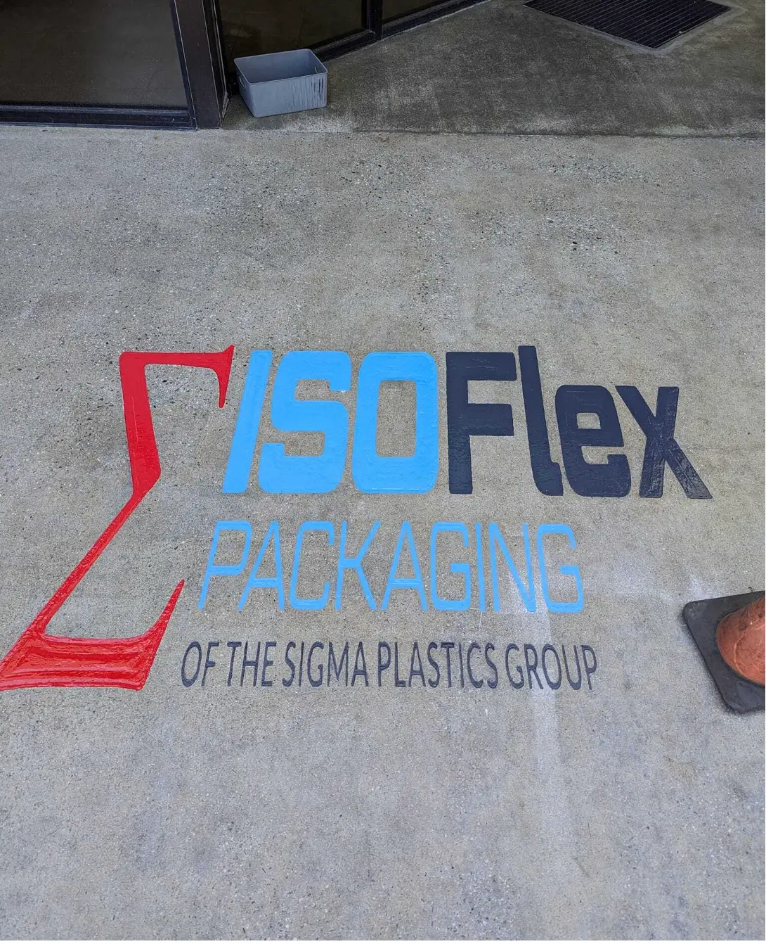 IsoFlex Packaging logo engraved and colored in concrete