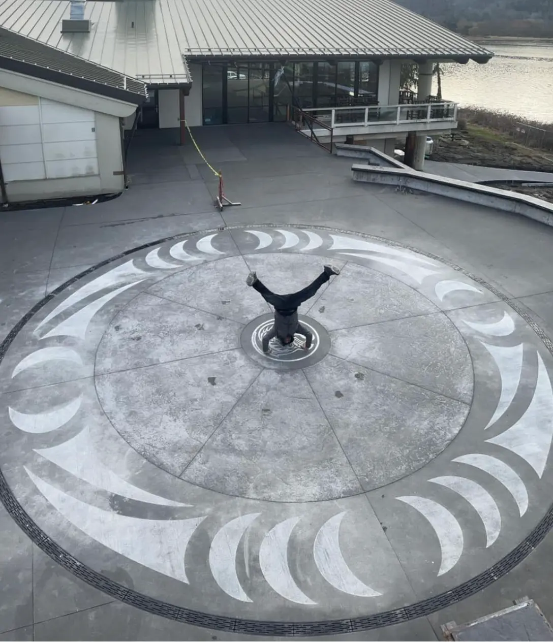 Large engraved concrete medallion on a waterfront plaza