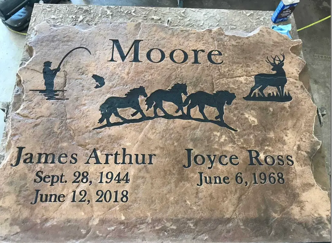 Family memorial stone engraved with horses, deer and angler scenes