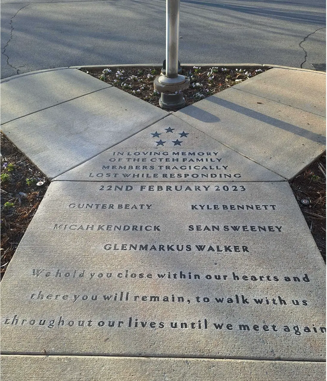 Engraved memorial concrete walkway with names and inscription