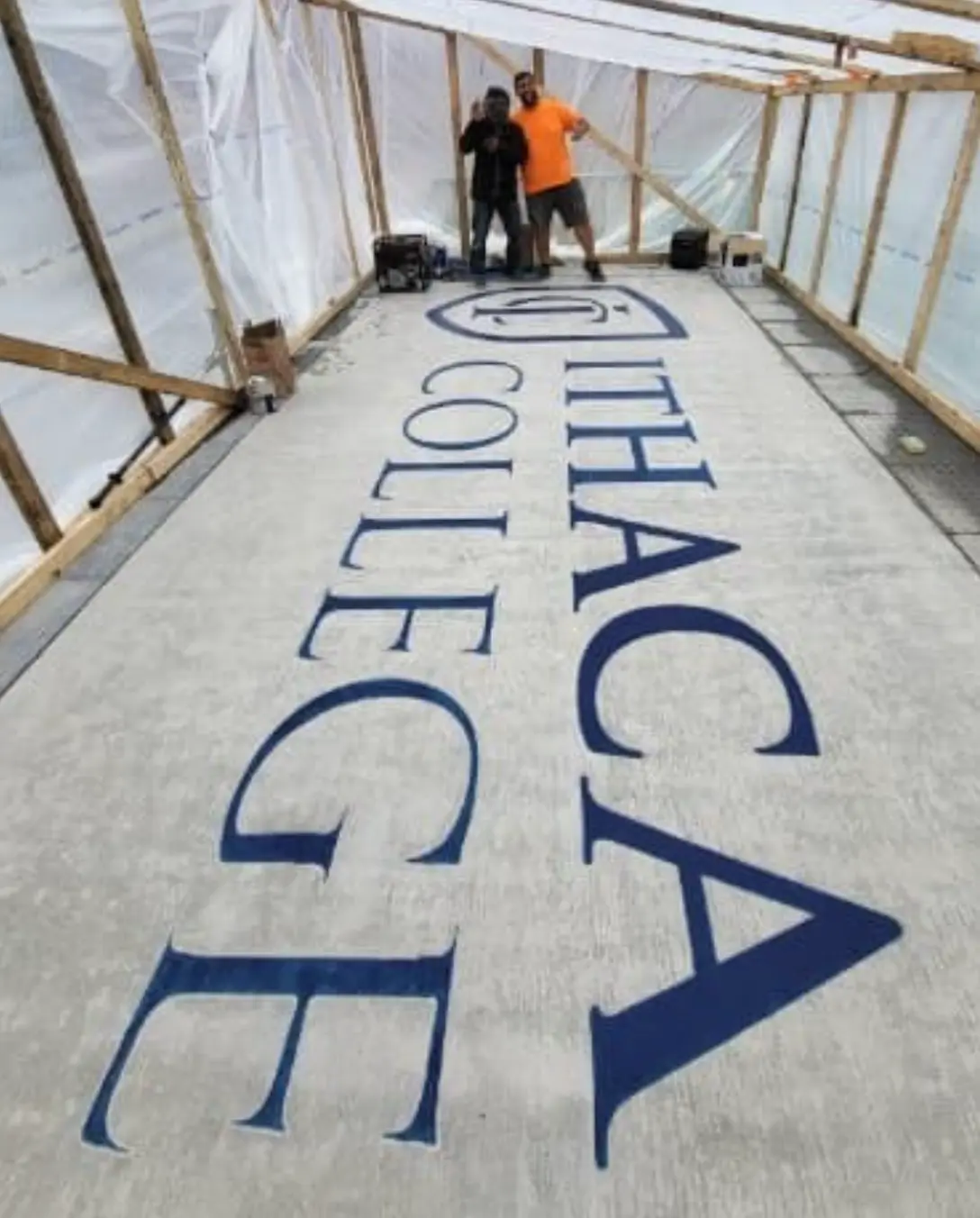 Ithaca College lettering engraved across a large concrete floor