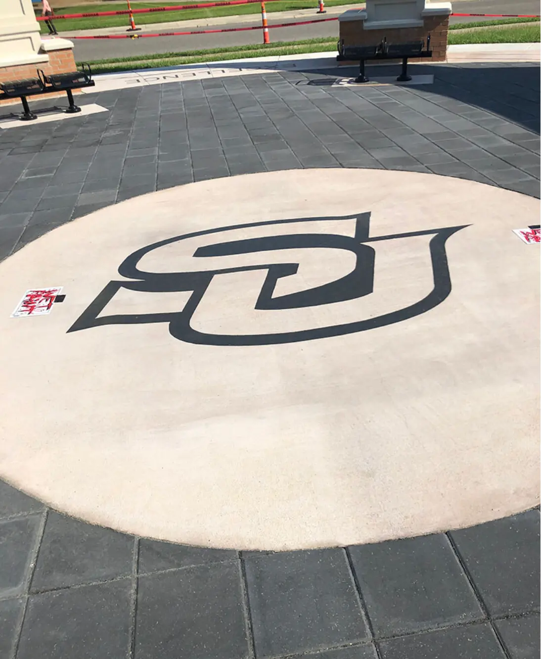 University monogram engraved into a circular concrete pad