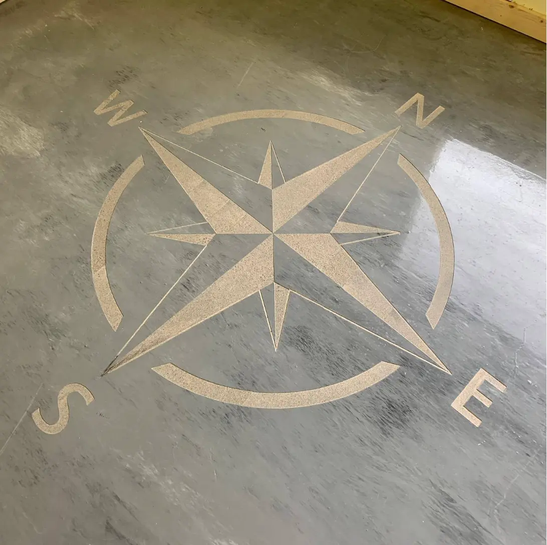 Compass rose engraved into a polished concrete floor